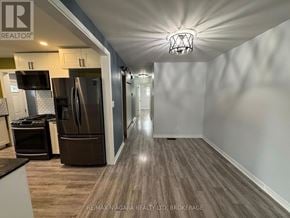 St. Catharines (Lakeport) apartment for rent - A spacious kitchen with wood flooring and modern appliances.