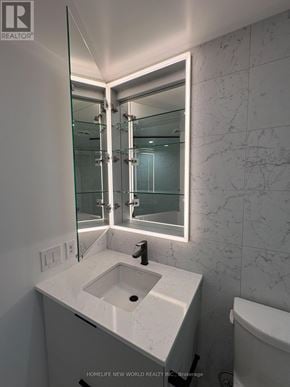 Toronto (North St. James Town) condo for rent - A white sink in a bathroom with a mirror above it.