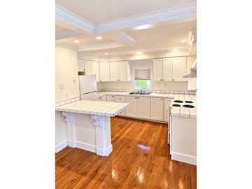 Gatineau (Hull) apartment for rent - A kitchen with white cabinets and a wooden floor.