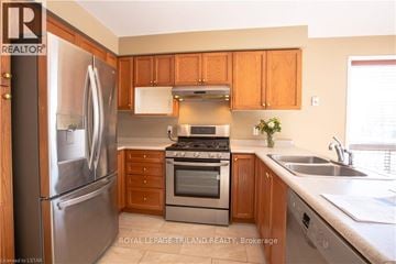 London North (North M) apartment for rent - A kitchen with wooden cabinets and stainless steel appliances.