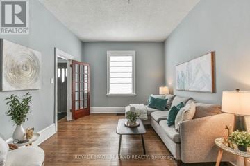 London East (East F) apartment for rent - A living room with a couch, a coffee table, and a painting on the wall.