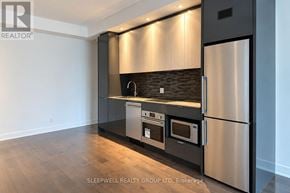 Ottawa condo for rent - A modern kitchen with stainless steel appliances and wooden flooring.