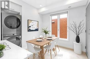 Ottawa multi-family for rent - A modern dining room with a wooden table and white chairs.