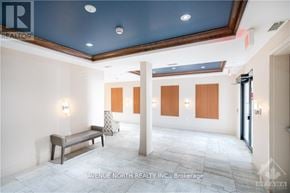 Ottawa condo for rent - A brokerage office with a bench and a pillar in the middle.