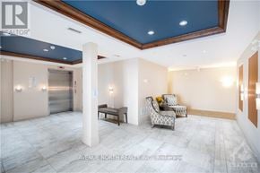 Ottawa condo for rent - A living room with a couch, chair, and a ceiling with lights.