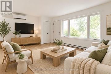 London East (East K) multi-family for rent - A living room with a couch, chair, and coffee table.