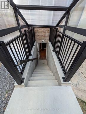 Mississauga (Churchill Meadows) apartment for rent - A staircase with a black railing and a glass ceiling.