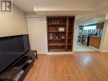 Mississauga (Churchill Meadows) apartment for rent - A living room with a television and a wooden cabinet.