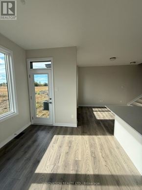 Ottawa townhouse for rent - A room with a wooden floor and a door leading outside.