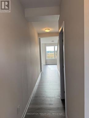 Ottawa townhouse for rent - A long hallway with a door at the end.