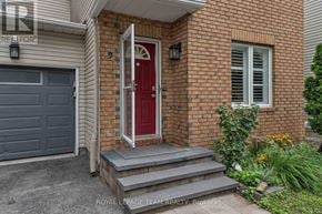Ottawa apartment for rent - A red door is on the front of a brick house.