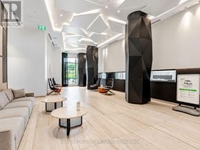 Toronto (Kensington-Chinatown) condo for rent - A modern office lobby with a wooden floor and a white wall.