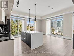 Toronto (Kensington-Chinatown) condo for rent - A modern kitchen with a large island and a view of the city.