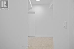 Toronto (Waterfront Communities) condo for rent - A white room with a door and a light switch on the wall.