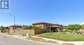 Vaughan (West Woodbridge) apartment for rent - A realtor photo of a residential area with houses and a street.