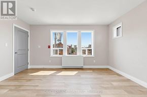 Hamilton (St. Clair) multi-family for rent - A room with a large window and a door.
