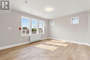 Hamilton (St. Clair) multi-family for rent - A room with a large window and a small picture window.