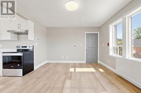 Hamilton (St. Clair) multi-family for rent - A kitchen with a stainless steel oven and wooden flooring.