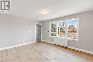 Hamilton (St. Clair) multi-family for rent - A room with a door and a window with a view of a building outside.