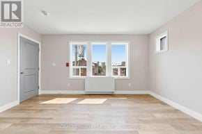 Hamilton (St. Clair) multi-family for rent - A room with a large window and a door.