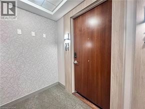 Kitchener condo for rent - A wooden door with a number 31 on it.