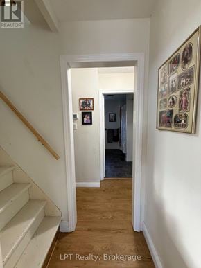 Prince Edward County (Hallowell Ward) apartment for rent - A hallway with a staircase on the left and a framed picture on the right.