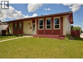 Calgary apartment for rent - A red and yellow house with a white door and windows.