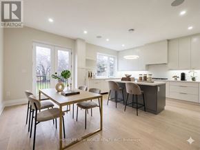 Toronto (Englemount-Lawrence) apartment for rent - A well-lit kitchen and dining area with a table set for four.