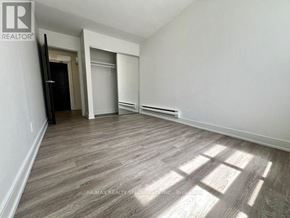 Toronto (Church-Yonge Corridor) condo for rent - A room with wooden flooring and white walls, with a door on the left and a closet on the right.