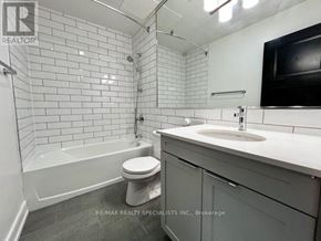 Toronto (Church-Yonge Corridor) condo for rent - A white tiled bathroom with a toilet, sink, and bathtub.
