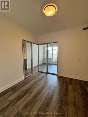 Waterloo condo for rent - A room with a sliding glass door and wooden flooring.
