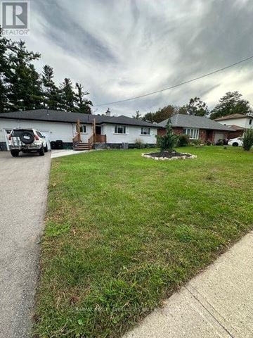 Barrie (Allandale Heights) apartment for rent - A realtor photo of a house with a car parked in front.