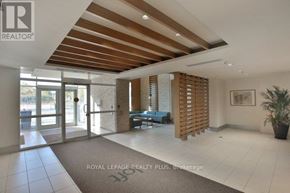 Toronto (Mimico) condo for rent - A spacious room with a wooden ceiling and a blue sofa.