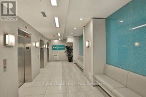 Toronto (Mimico) condo for rent - A hallway with a plant in the middle and a sign that says "California".