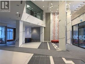 Toronto (Henry Farm) condo for rent - A lobby with a marble floor and a glass wall.