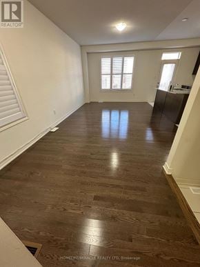 Brampton (Northwest Brampton) apartment for rent - A spacious room with wooden flooring and white walls.