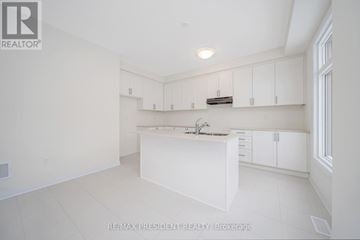Erin apartment for rent - A white kitchen with a sink and cabinets.