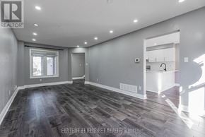 Whitby (Williamsburg) apartment for rent - A spacious room with grey walls and wooden flooring.