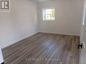 Ottawa apartment for rent - A room with wooden flooring and a window.