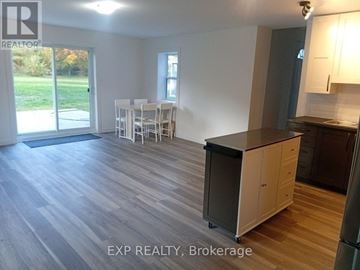 Ottawa apartment for rent - A kitchen area with a dining table and chairs in a room with EXP REALTY, Brokerage watermark.
