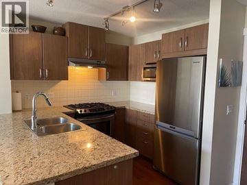 Coquitlam apartment for rent - A kitchen with a granite countertop and stainless steel appliances.