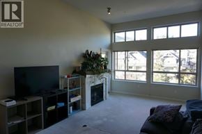 Coquitlam apartment for rent - A living room with a fireplace and a television.