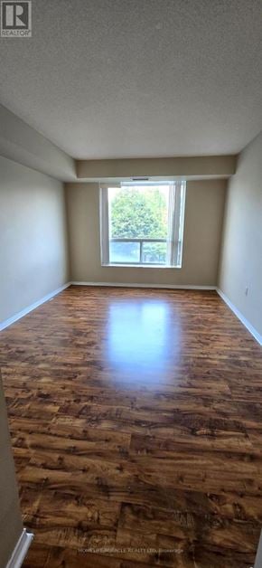 Toronto (Newtonbrook East) condo for rent - A room with wooden flooring and a window.