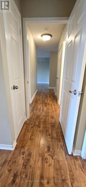 Toronto (Newtonbrook East) condo for rent - A long hallway with white doors on either side and wooden floors.