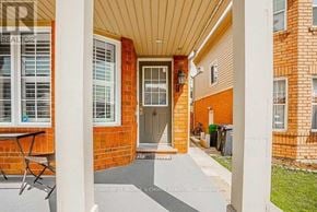 Brampton (Fletcher's Meadow) apartment for rent - A red brick house with a porch and a table and chairs on it.