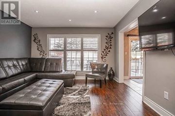 Brampton (Fletcher's Meadow) apartment for rent - A living room with a leather couch and a flat screen TV mounted on the wall.
