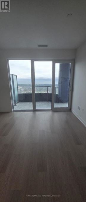 Mississauga (City Centre) condo for rent - A room with a view of the ocean through a sliding glass door.