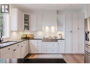 Langdale apartment for rent - A modern kitchen with white cabinets and a wooden floor.