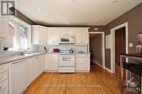 Ottawa triplex for rent - A kitchen with white appliances and cabinets.