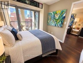 Toronto (Moss Park) condo for rent - A bedroom with a large bed and a painting on the wall.